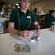 A server pours a cafecito in Miami’s famed Cafe Versailles